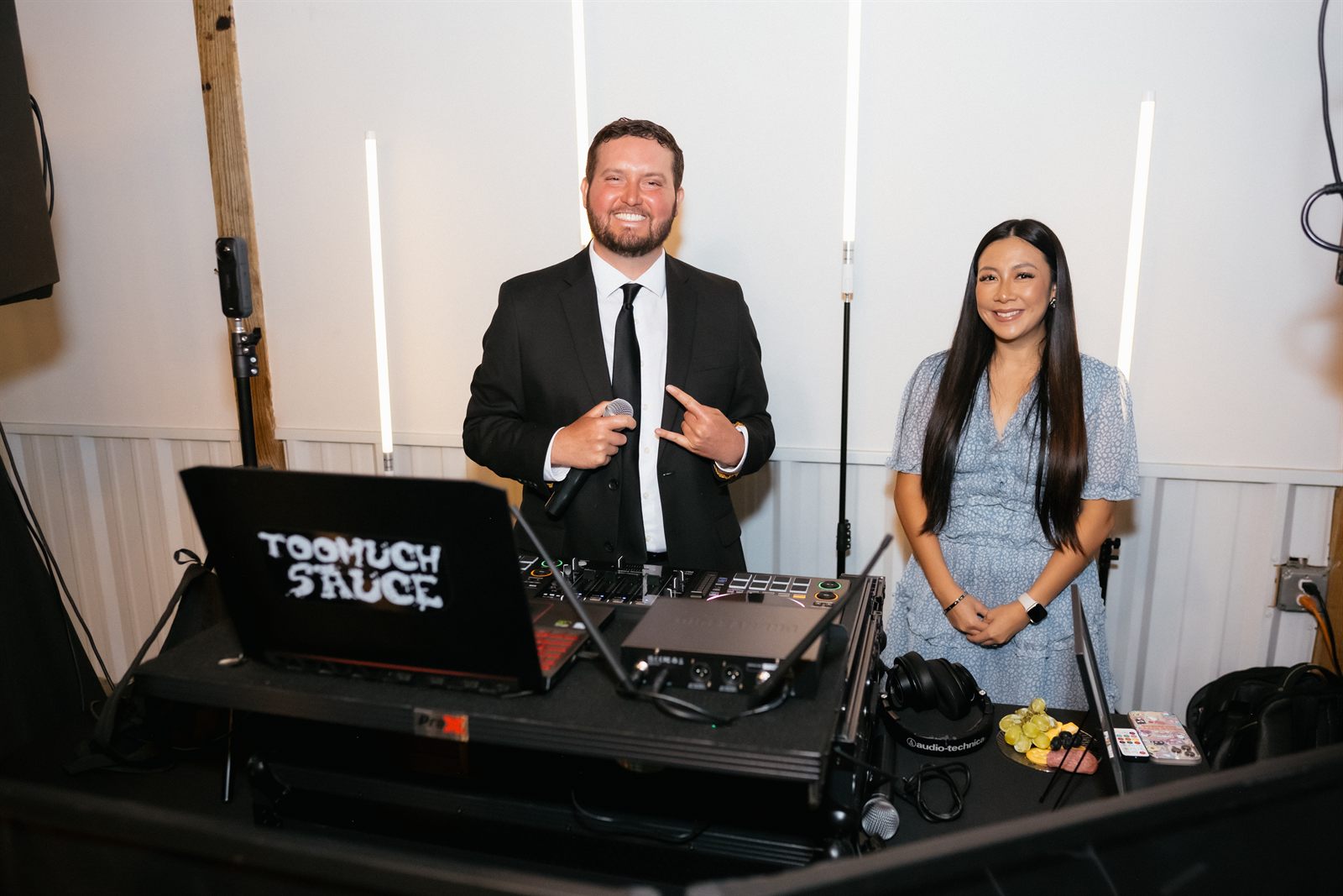 DJ with couple at booth